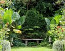 Matching benches in in shady areas of the garden offer views along secondary axis